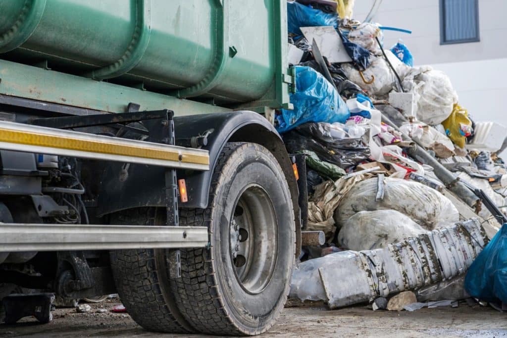 Dump truck emptying bags of trash